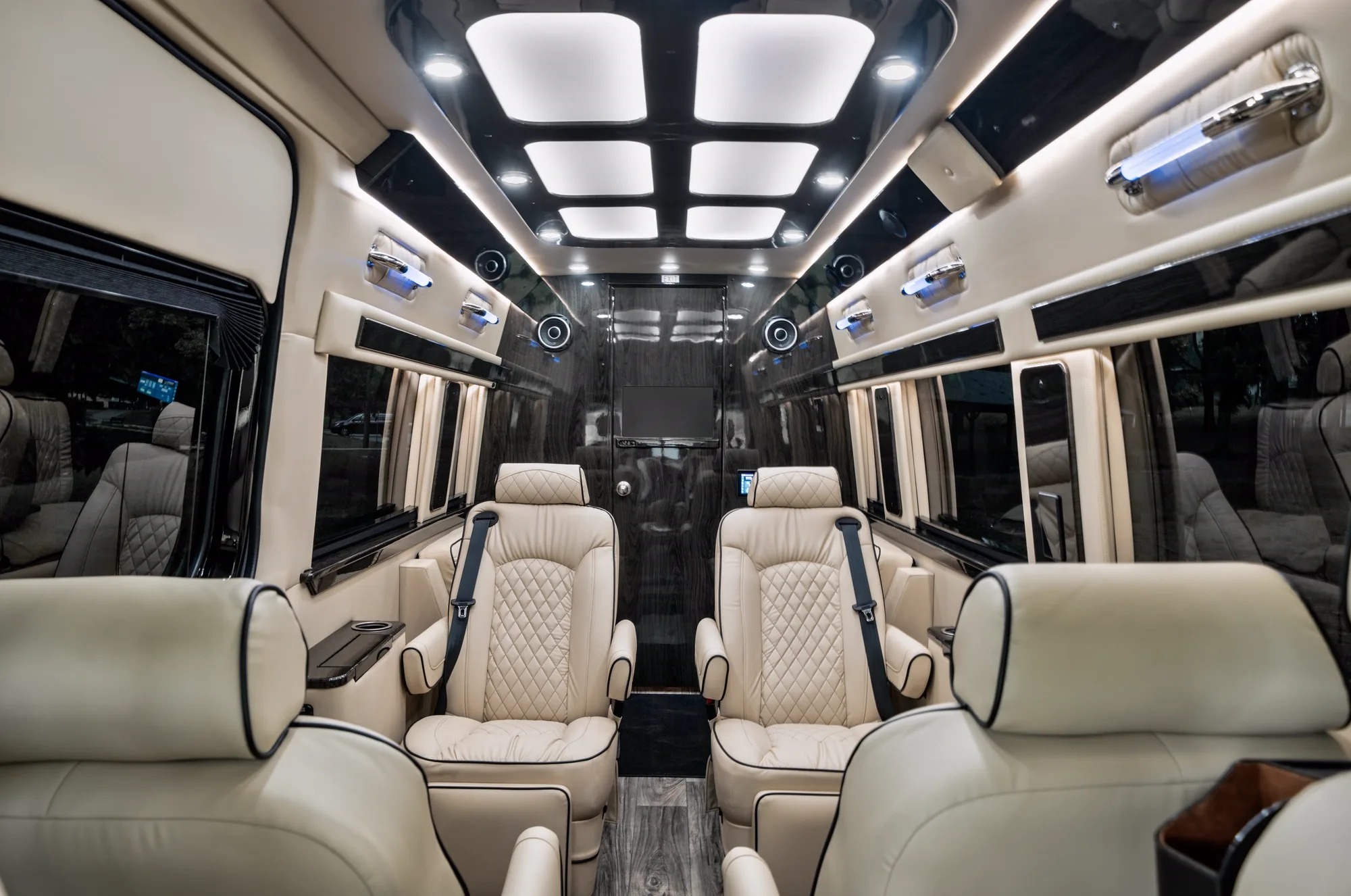 Jet-Style Sprinter interior — captain's chairs, conference setup, skylights