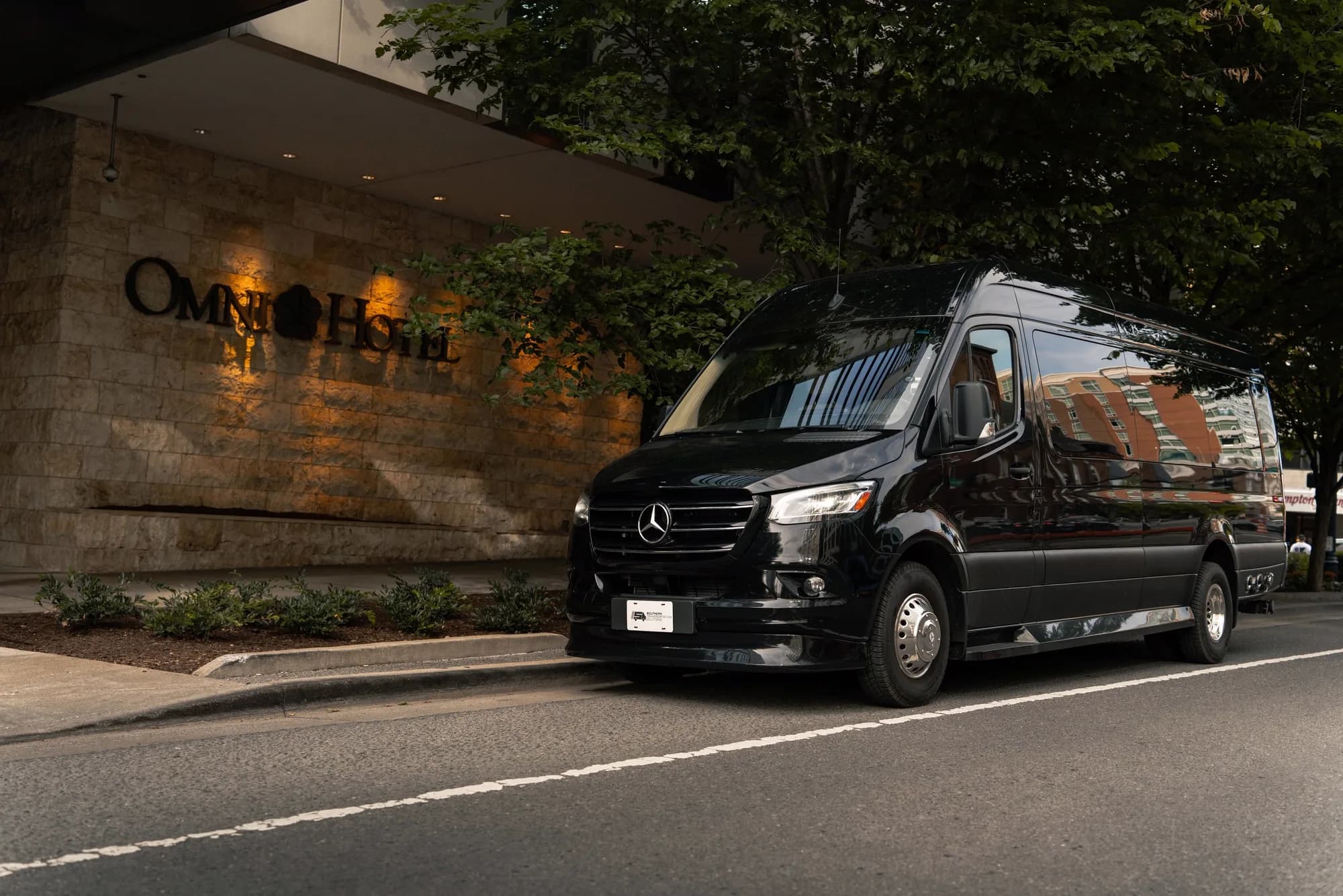 Black Jet-Style Sprinter front three-quarter view in low, executive lighting