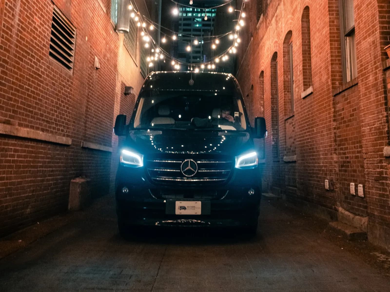 STS Nashville Jet-Style Sprinter under string lights in a brick alley at night