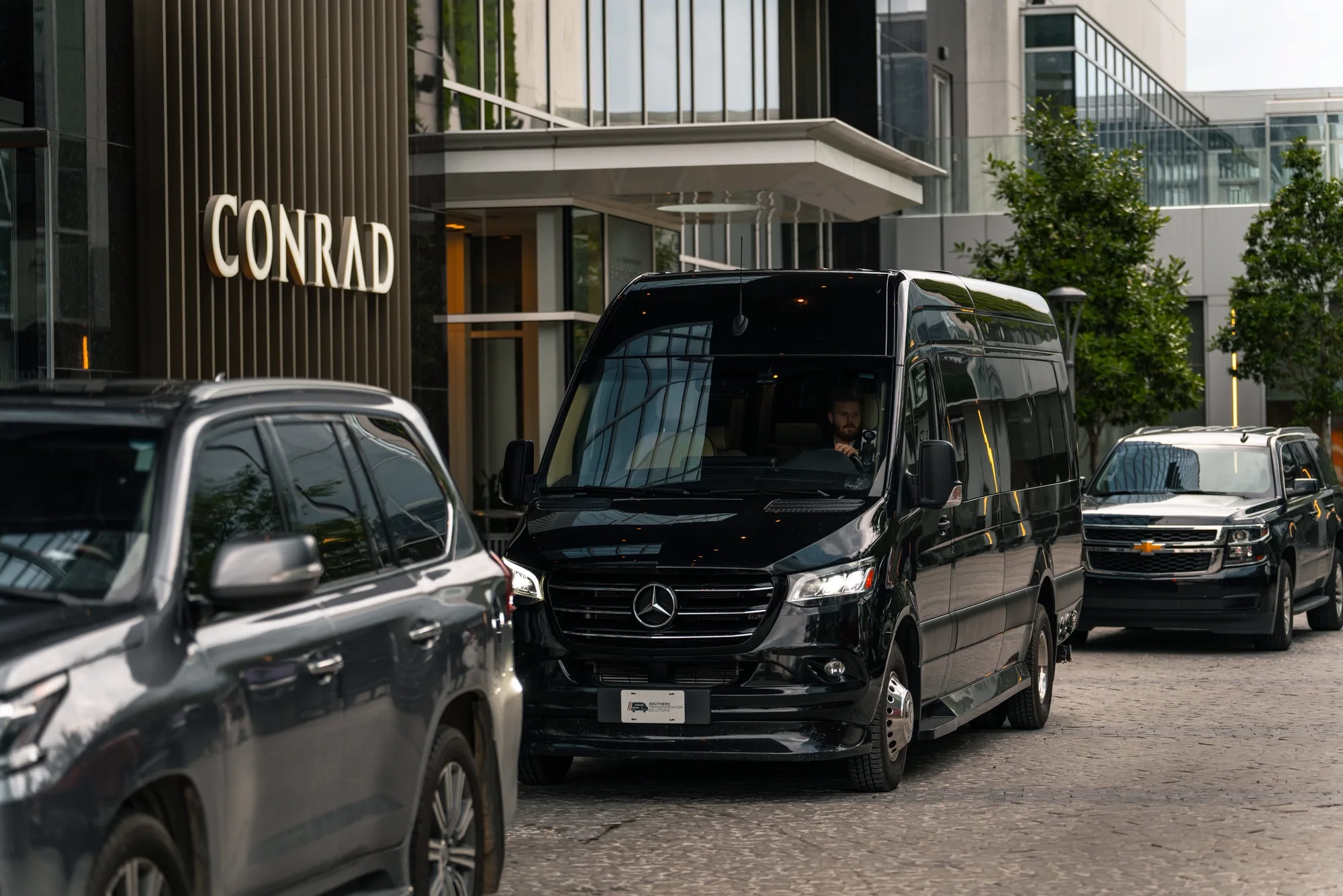 Jet-Style Sprinter and a black SUV at the Conrad Nashville hotel